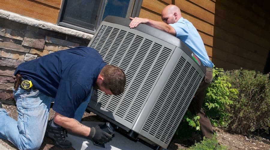 technicians repairing the ac unit