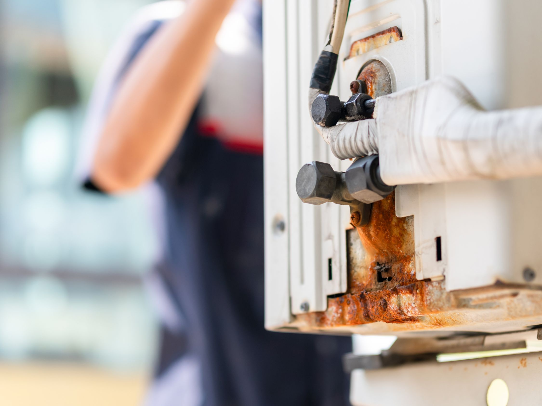 Rust and corrosion visible on an outdoor AC unit connection point.
